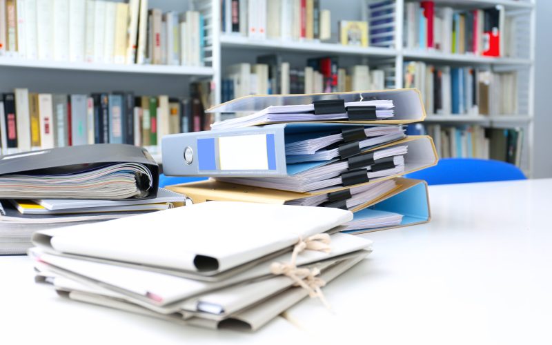 Folders with documents on table in archive