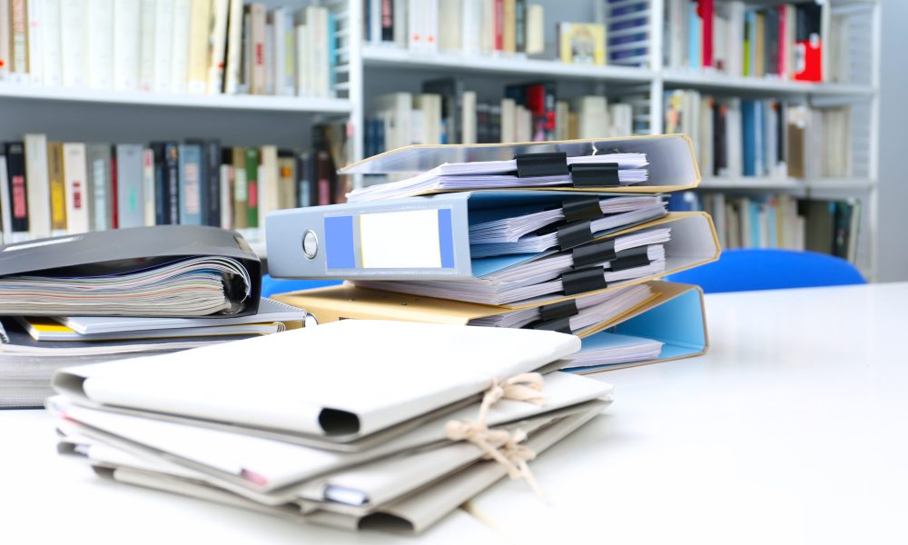 Folders with documents on table in archive